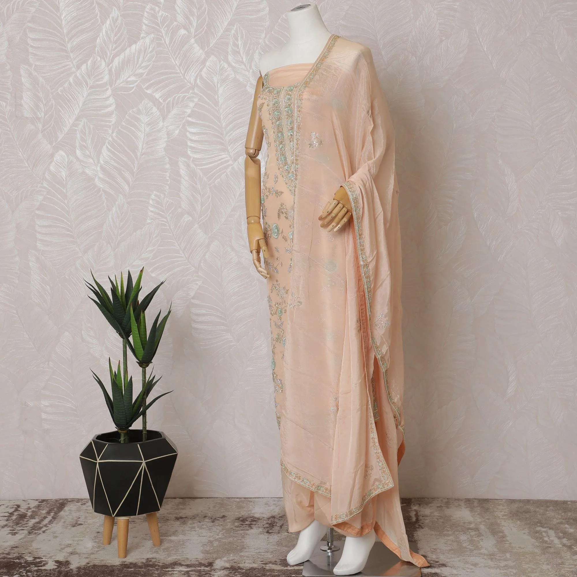 Light peach Premium pure silk crepe kameez with mint green embroidery, sequin work and stone work in floral design. Light peach plain salwar with same tone chiffon dupatta with same tone embroidery and bead work-D15577