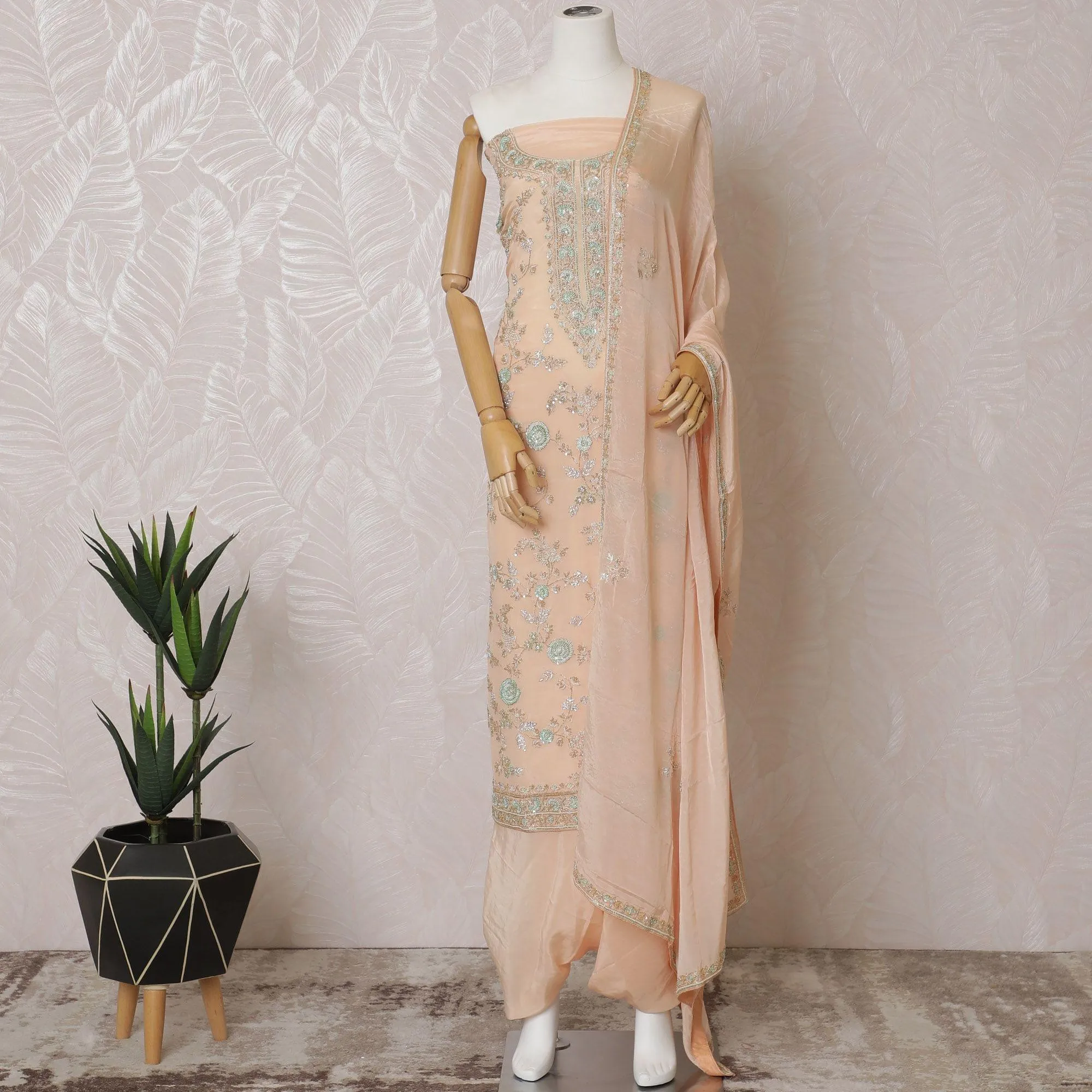 Light peach Premium pure silk crepe kameez with mint green embroidery, sequin work and stone work in floral design. Light peach plain salwar with same tone chiffon dupatta with same tone embroidery and bead work-D15577